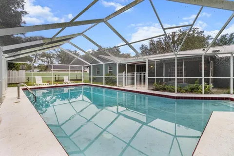 a view of a house with backyard and porch