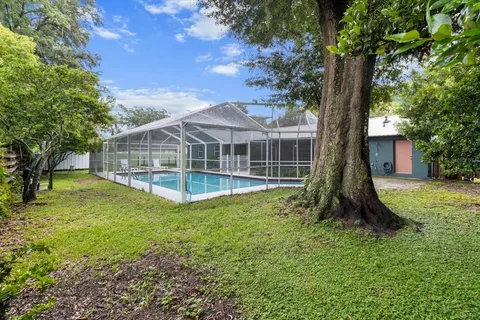a view of a house with a yard and a garden