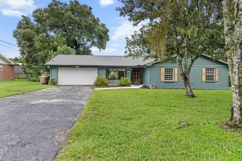 a front view of house with yard and green space