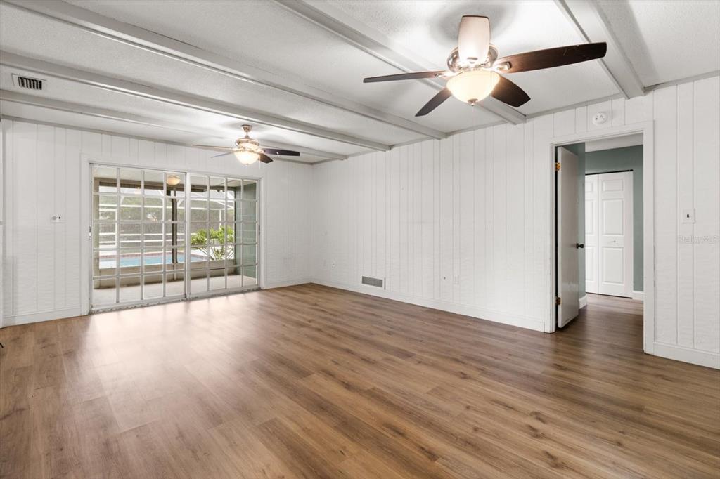 4015 Southeast 15th Street Ocala, FL 34471 - Photo 10 of 46 a view of an empty room with wooden floor and a window