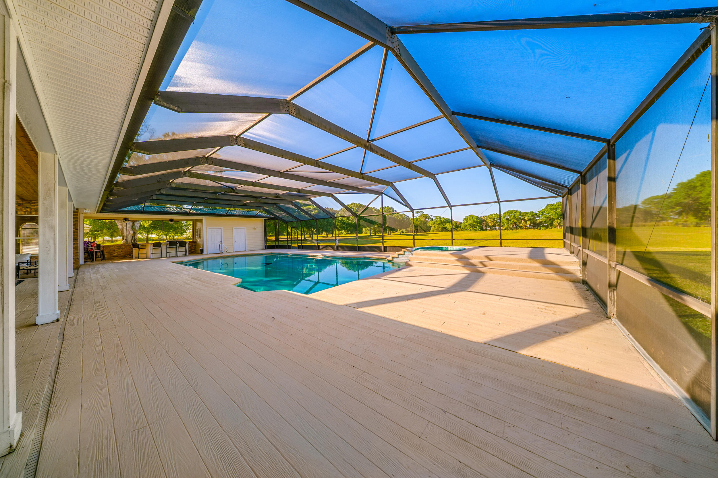 8686 Andrews Avenue Fort Pierce, FL 34945 - Photo 58 of 76 a view of garage with a table and chairs under an umbrella