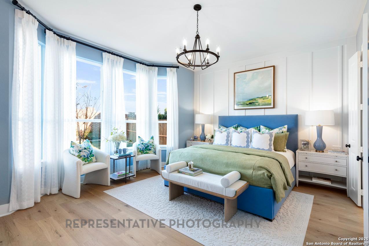 4412 Wendell Way Schertz, TX 78108 - Photo 14 of 28 a spacious bedroom with a bed and a chandelier