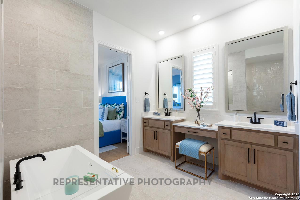 4412 Wendell Way Schertz, TX 78108 - Photo 19 of 28 a spacious bathroom with a tub sink and mirror