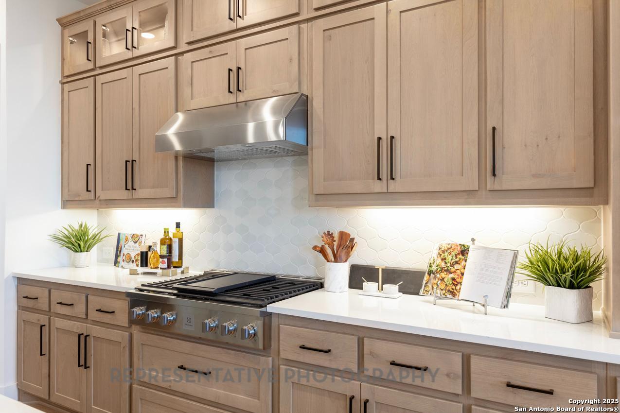 4412 Wendell Way Schertz, TX 78108 - Photo 5 of 28 a kitchen with stainless steel appliances granite countertop a sink a stove and cabinets