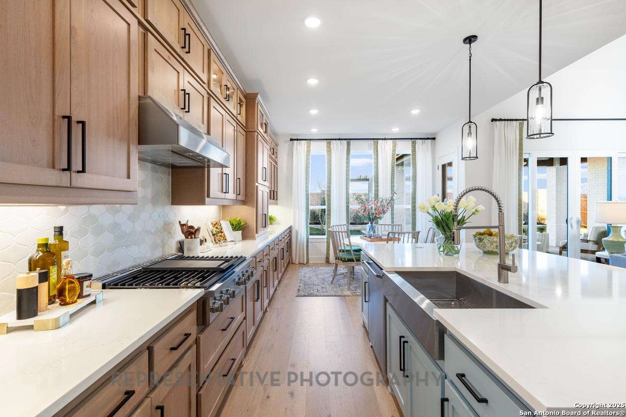 4412 Wendell Way Schertz, TX 78108 - Photo 6 of 28 a kitchen with stainless steel appliances a sink stove and cabinets