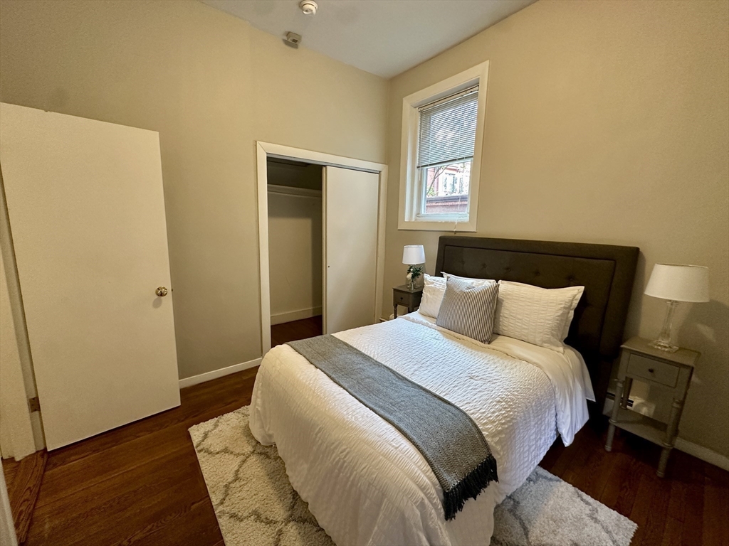 30 Pinckney Street, Unit 2 Boston, MA 02114 - Photo 11 of 18 a bedroom with a bed and wooden floor