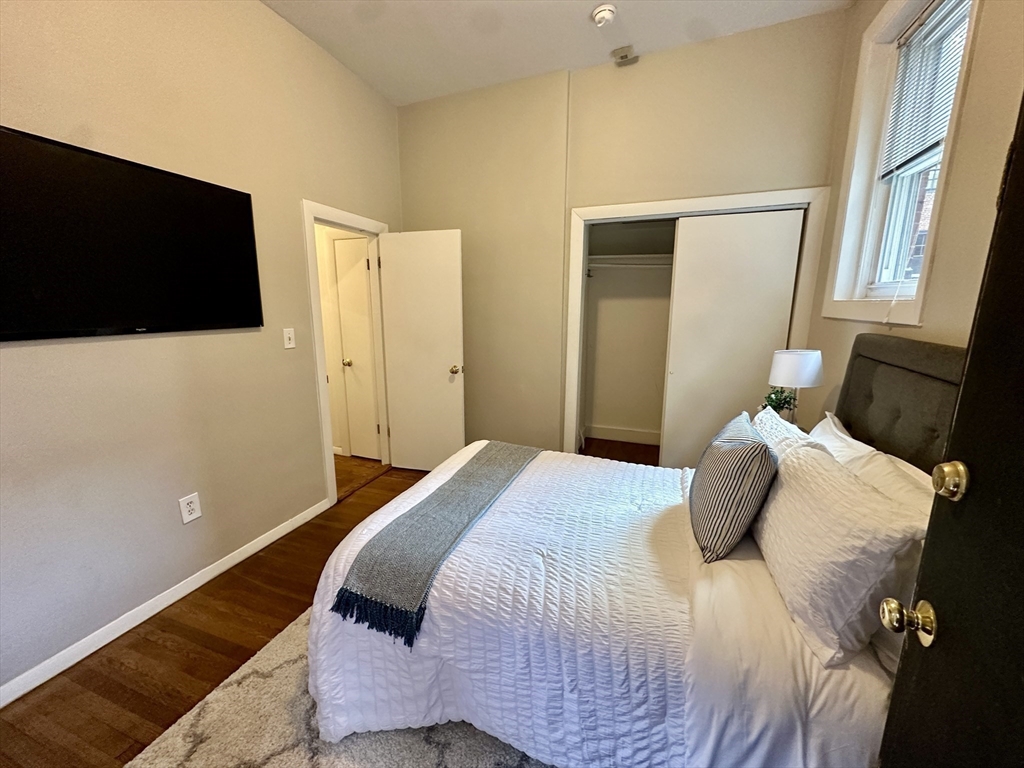 30 Pinckney Street, Unit 2 Boston, MA 02114 - Photo 12 of 18 a bedroom with a bed and a flat screen tv