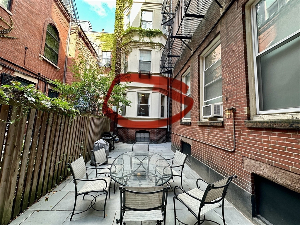 30 Pinckney Street, Unit 2 Boston, MA 02114 - Photo 15 of 18 a view of a patio with a table and chairs