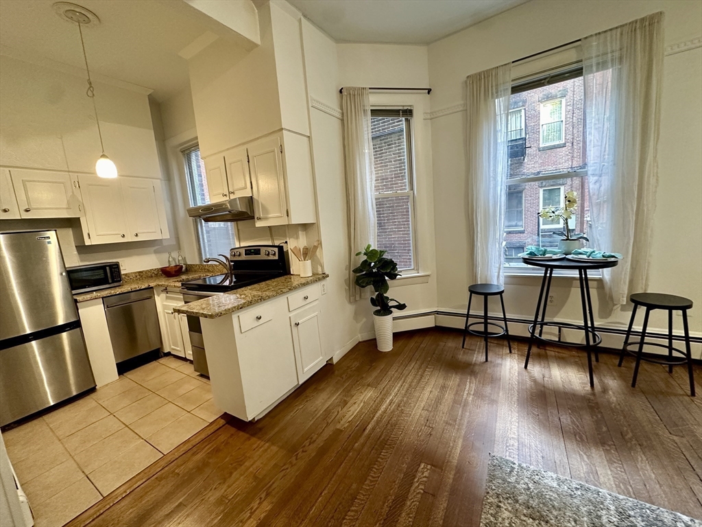 30 Pinckney Street, Unit 2 Boston, MA 02114 - Photo 2 of 18 a kitchen with sink cabinets and wooden floor