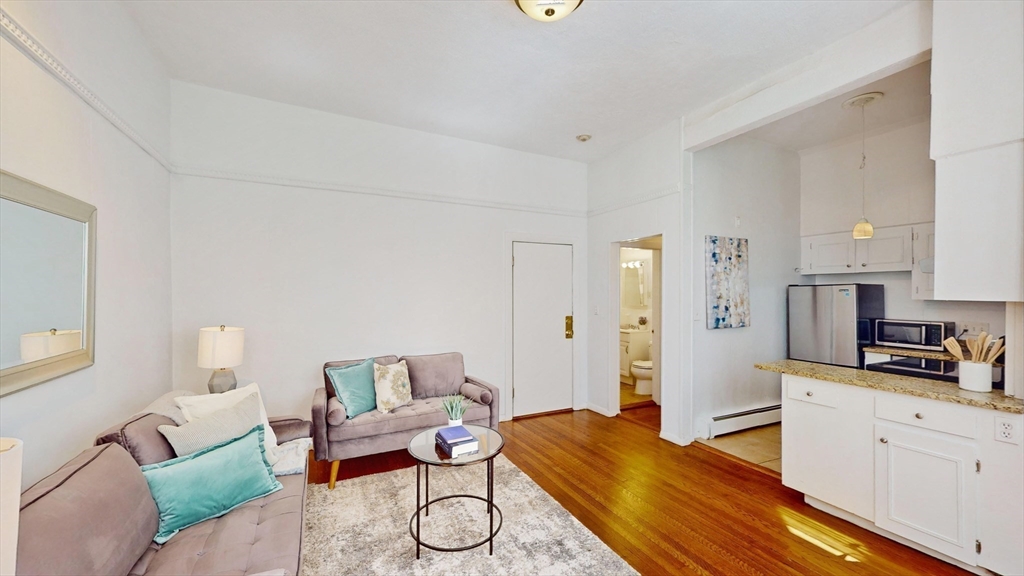 30 Pinckney Street, Unit 2 Boston, MA 02114 - Photo 4 of 18 a bedroom with furniture and a wooden floor