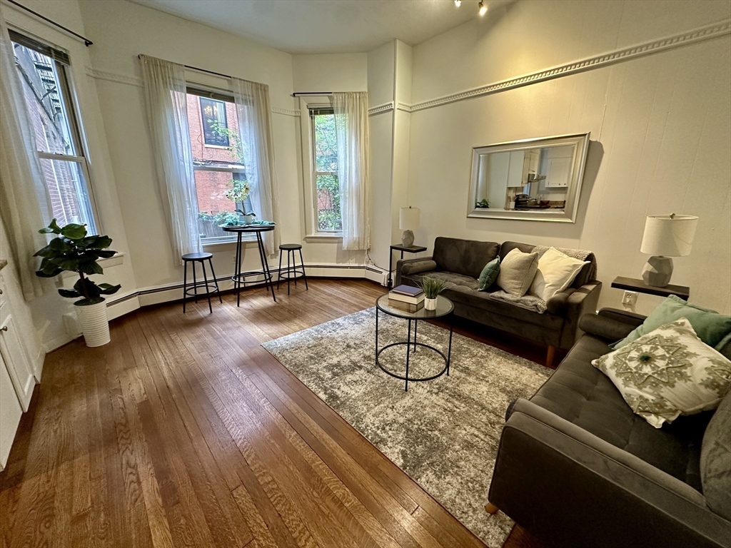 30 Pinckney Street, Unit 2 Boston, MA 02114 - Photo 7 of 18 a living room with furniture and wooden floor