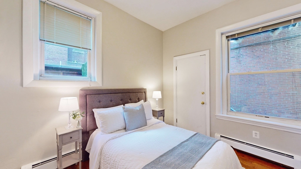 30 Pinckney Street, Unit 2 Boston, MA 02114 - Photo 9 of 18 a bed room with a bed and a window