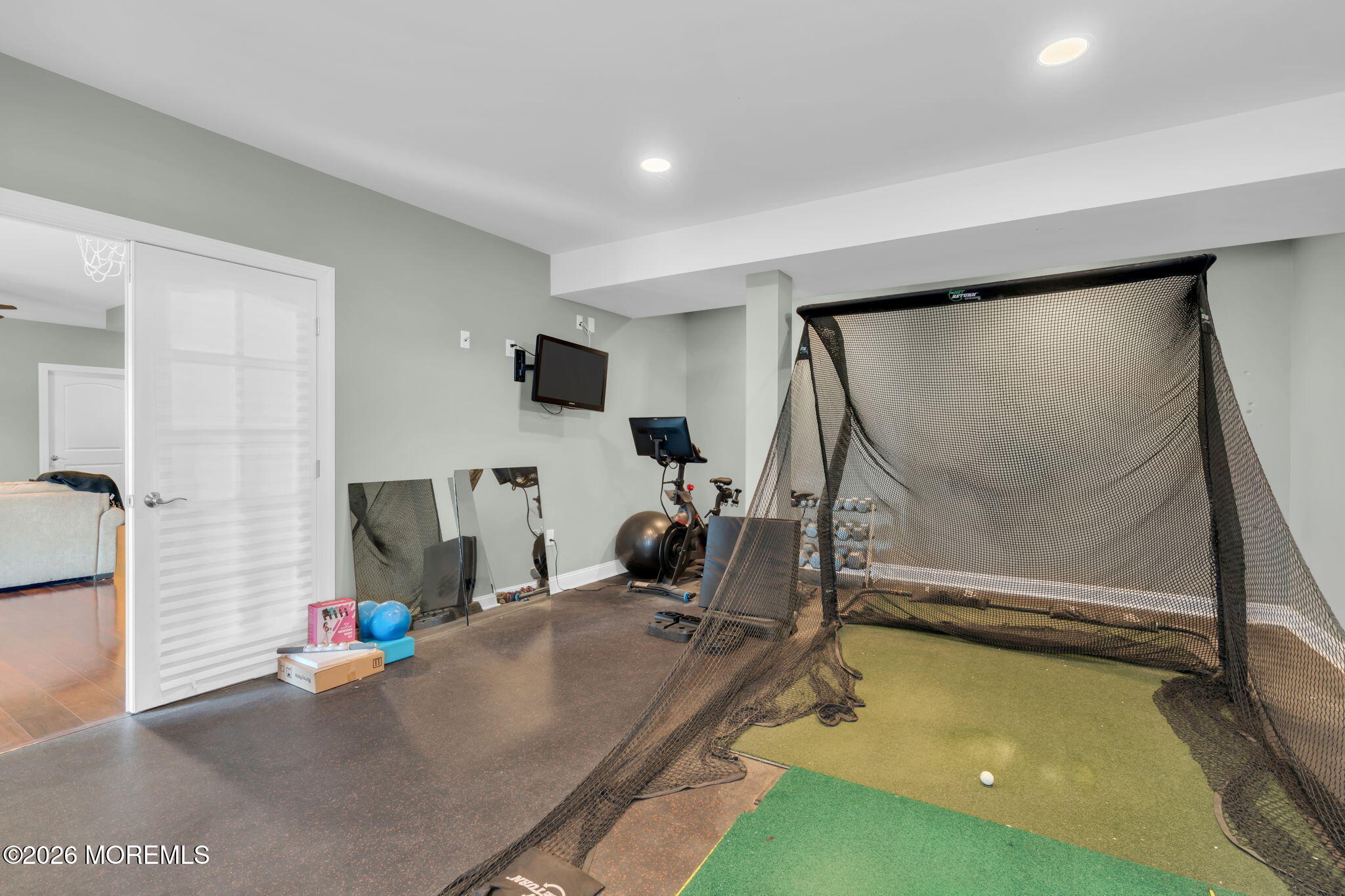 42 Ridgeview Way Allentown, NJ 08501 - Photo 37 of 47 a room with gym equipment and a flat screen tv