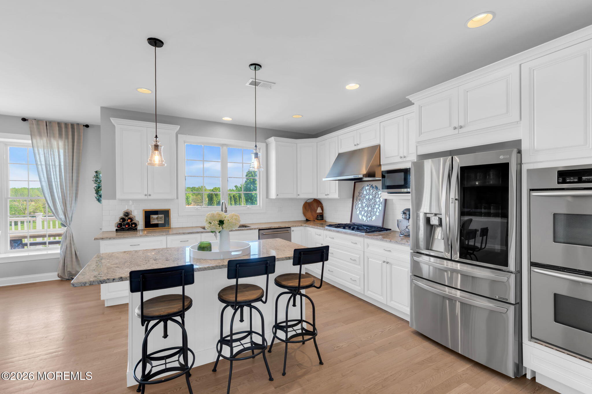 42 Ridgeview Way Allentown, NJ 08501 - Photo 4 of 47 a kitchen with stainless steel appliances kitchen island granite countertop a stove a sink a oven a dining table and chairs with wooden floor