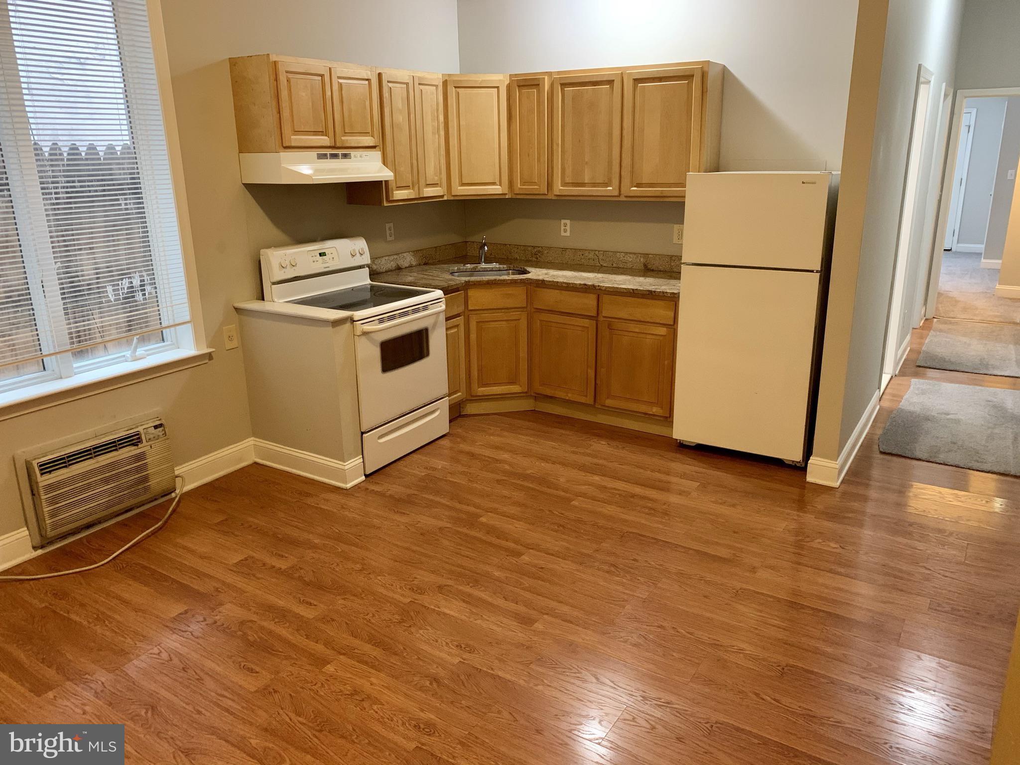 4439 Chestnut Street, Unit 1R Philadelphia, PA 19104 - Photo 3 of 22 a kitchen with wooden cabinets and white appliances