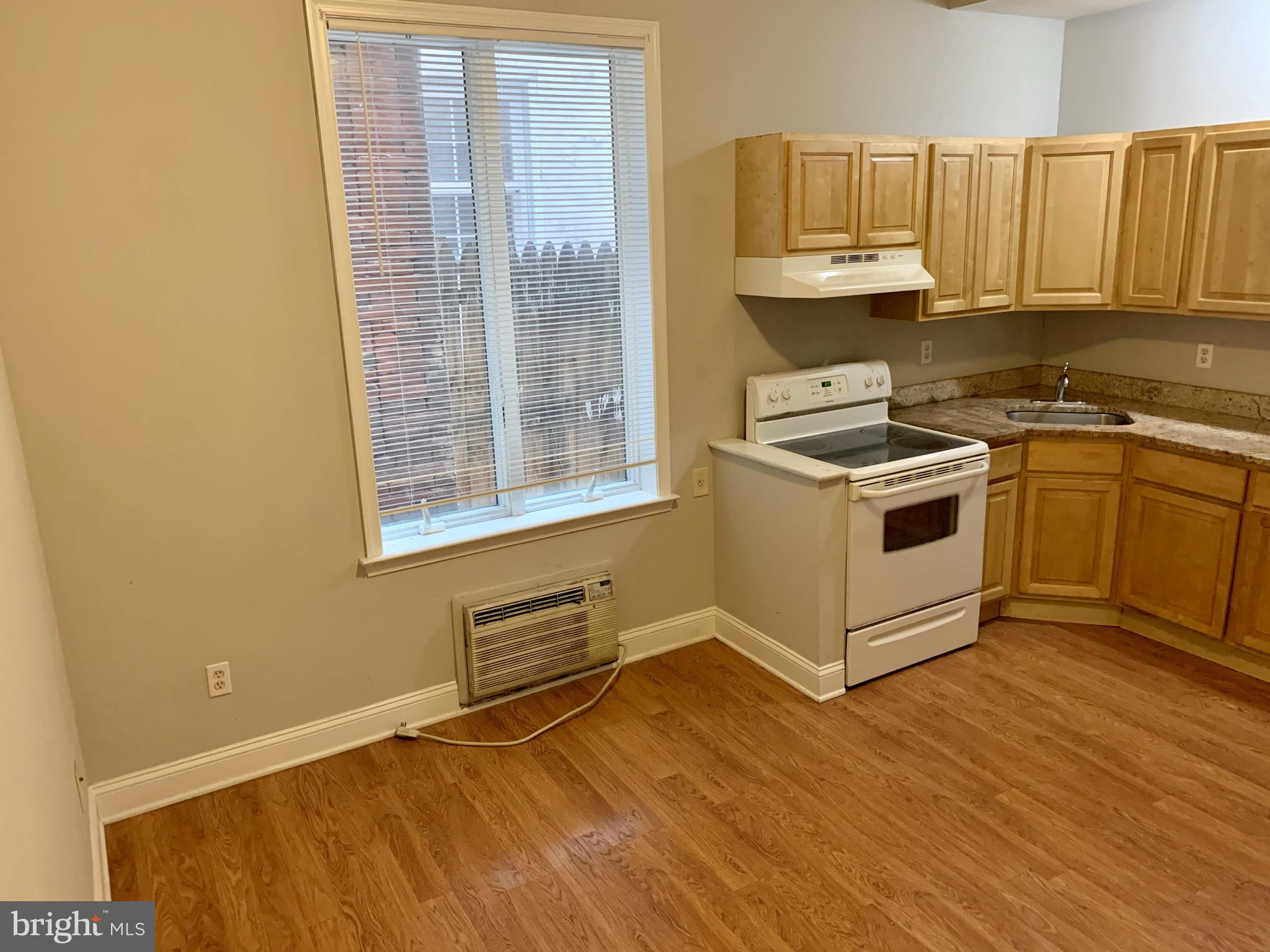 4439 Chestnut Street, Unit 1R Philadelphia, PA 19104 - Photo 6 of 22 a kitchen with stainless steel appliances granite countertop a stove a sink and a microwave