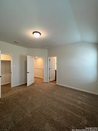 an empty room with fan and windows
