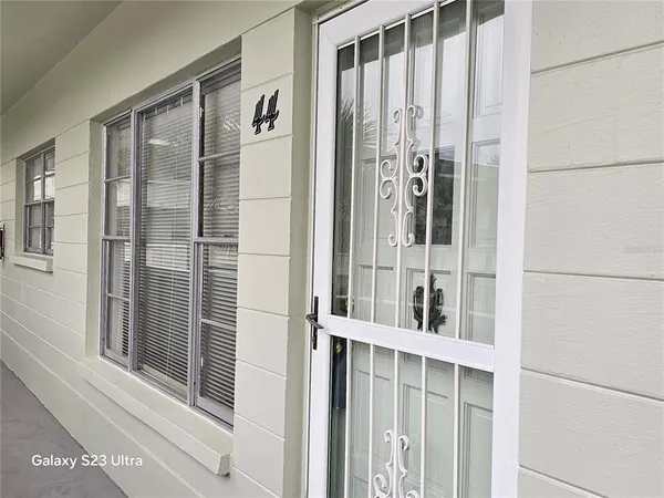 a view of a balcony with wooden floor and door
