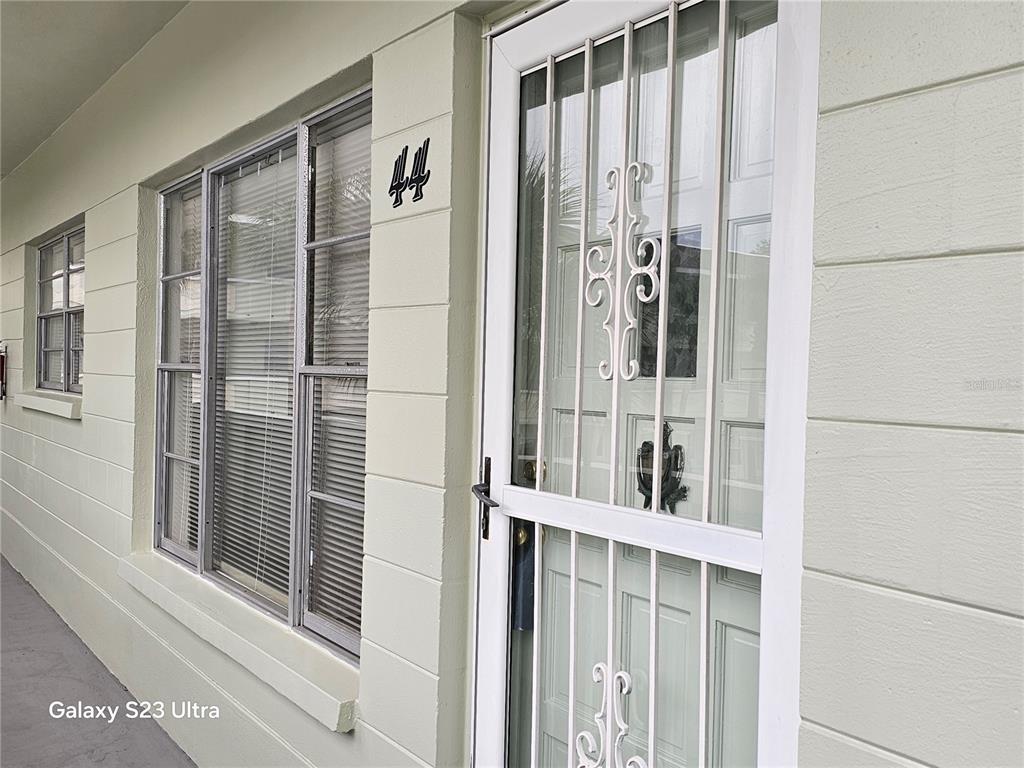 2386 Sumatran Way, Unit 44 Clearwater, FL 33763 - Photo 2 of 25 a view of a balcony with wooden floor and door