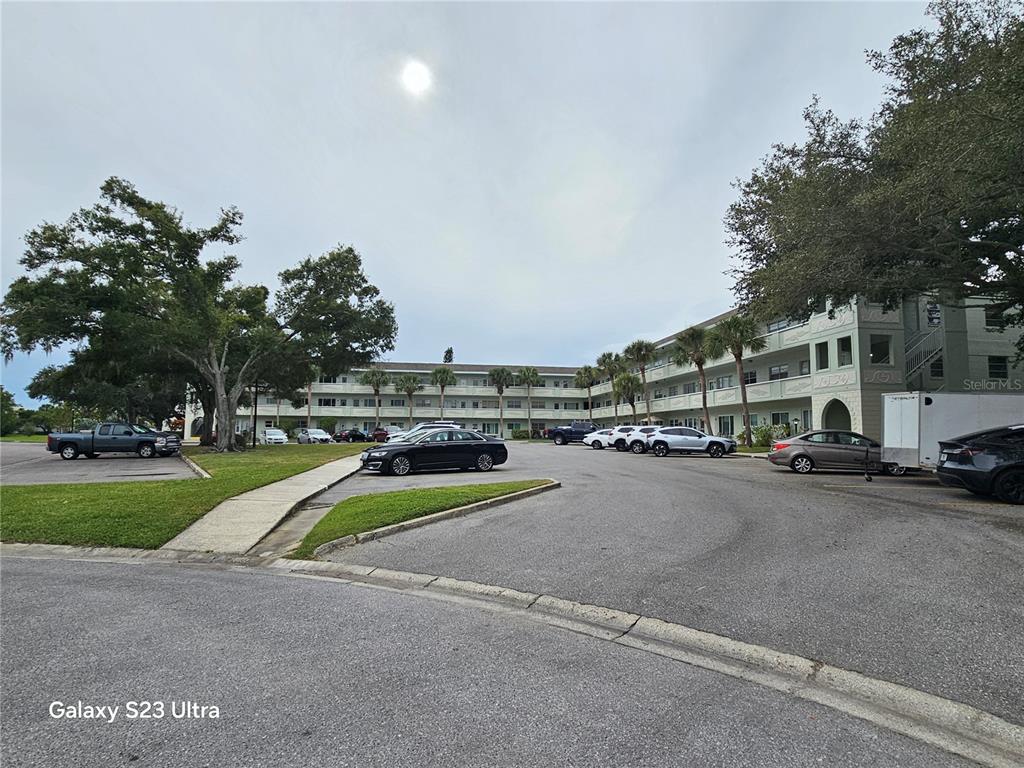 2386 Sumatran Way, Unit 44 Clearwater, FL 33763 - Photo 25 of 25 a view of a city street with a building and cars park