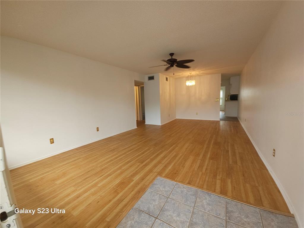 2386 Sumatran Way, Unit 44 Clearwater, FL 33763 - Photo 3 of 25 a view of a big room with wooden floor and windows
