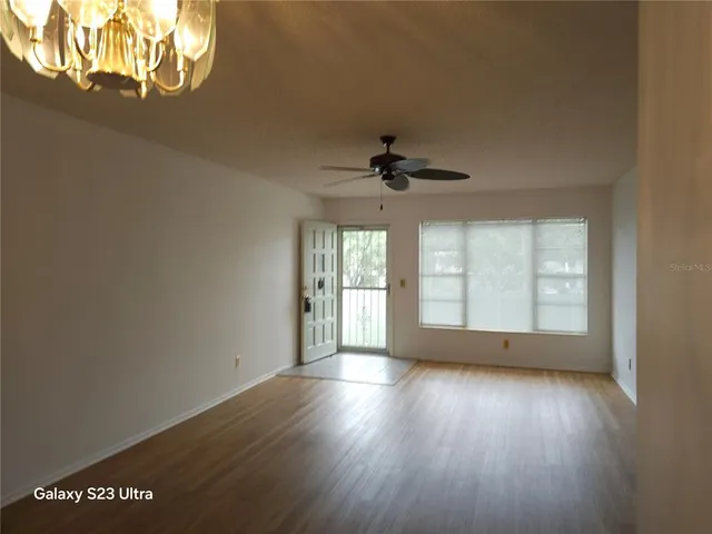 a kitchen with white cabinets and refrigerator