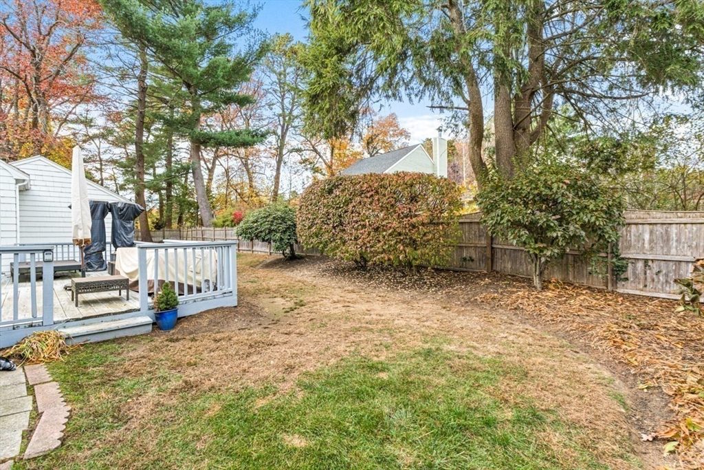 35 Garrison Road Wellesley, MA 02482 - Photo 25 of 28 a view of backyard with wooden fence and large trees