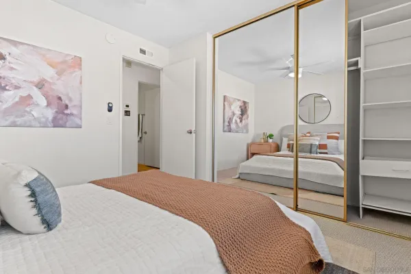 a bedroom with a bed and a painting on the wall