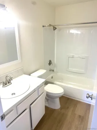 a bathroom with a sink a toilet and a bathtub