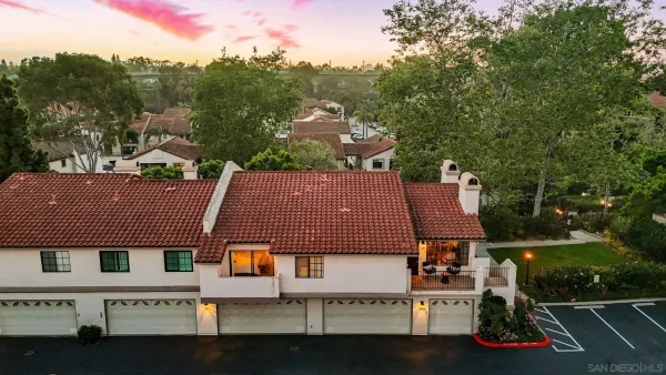 an aerial view of residential houses with outdoor space and street view