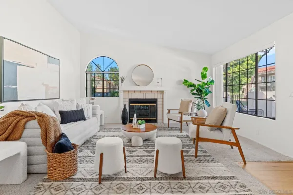 a living room with furniture a window and a fireplace