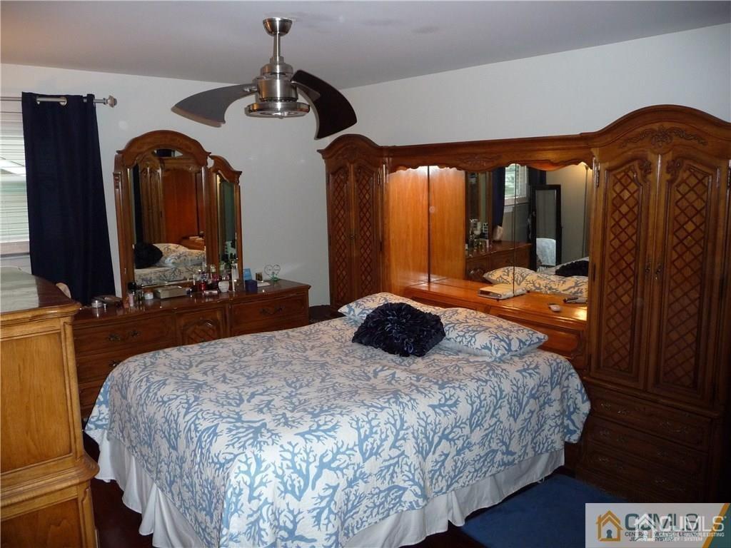 116 Prentice Avenue South River, NJ 08882 - Photo 22 of 27 a bedroom with a bed and dresser with mirror
