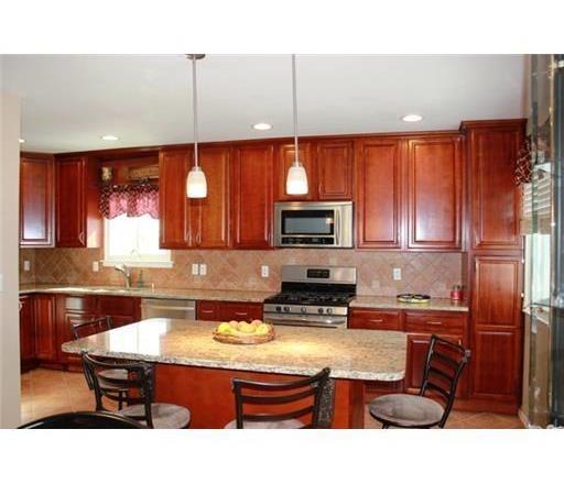 116 Prentice Avenue South River, NJ 08882 - Photo 5 of 27 a kitchen with kitchen island granite countertop a sink counter top space cabinets and stainless steel appliances