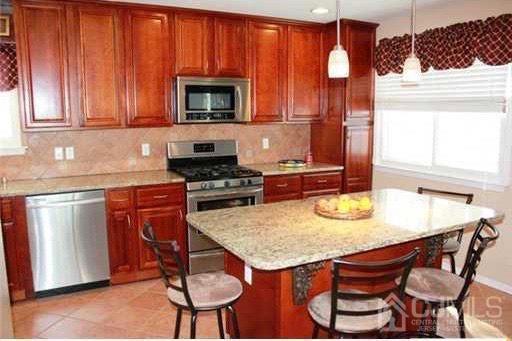 116 Prentice Avenue South River, NJ 08882 - Photo 7 of 27 a kitchen with a stove a sink and a microwave