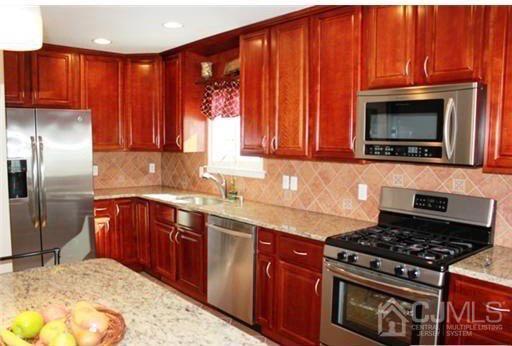 116 Prentice Avenue South River, NJ 08882 - Photo 8 of 27 a kitchen with stainless steel appliances granite countertop a stove a sink dishwasher and a microwave oven with granite countertops