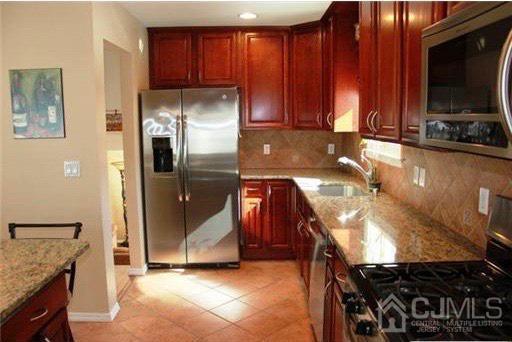 116 Prentice Avenue South River, NJ 08882 - Photo 9 of 27 a kitchen with stainless steel appliances granite countertop a refrigerator and a stove