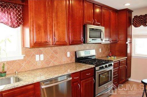 116 Prentice Avenue South River, NJ 08882 - Photo 10 of 27 a kitchen with granite countertop wood cabinets stainless steel appliances and a sink