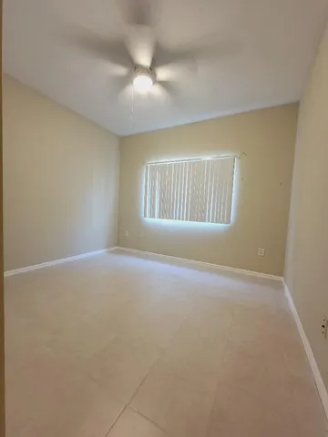 an empty room with a empty space and windows