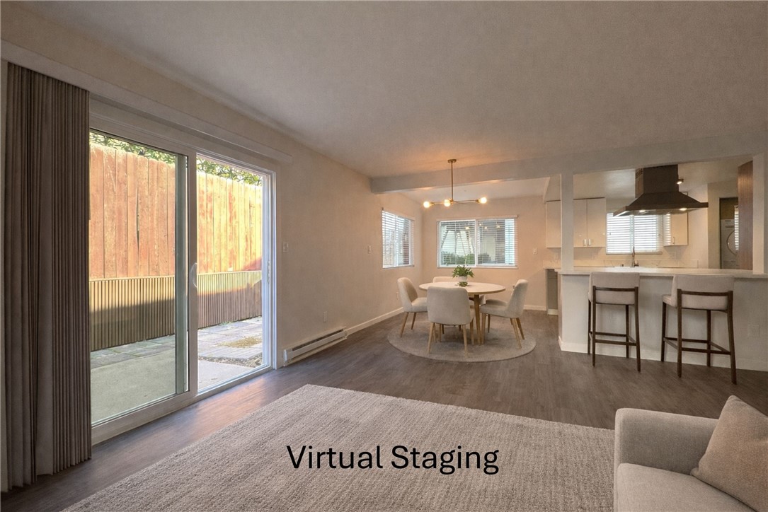 a living room with furniture a dining table and a large window