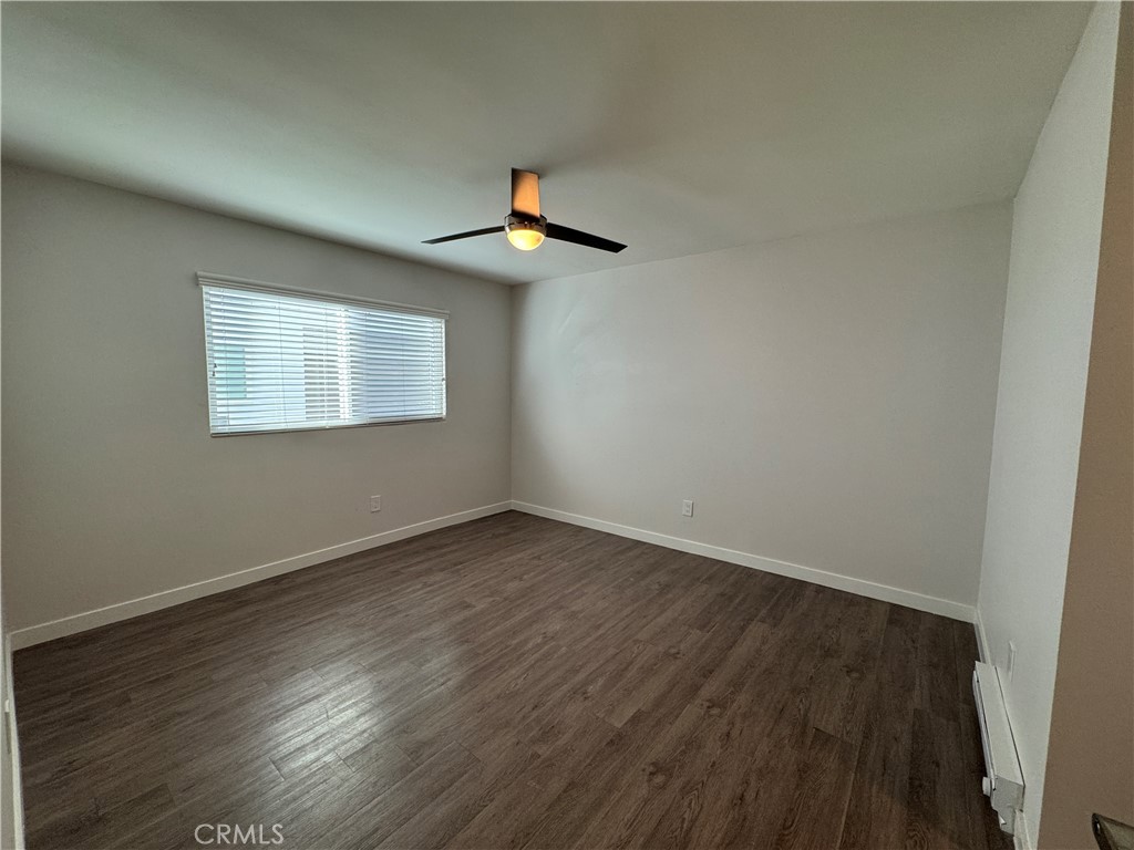 1102 Barbara Street, Unit B Redondo Beach, CA 90277 - Photo 11 of 22 an empty room with wooden floor and windows