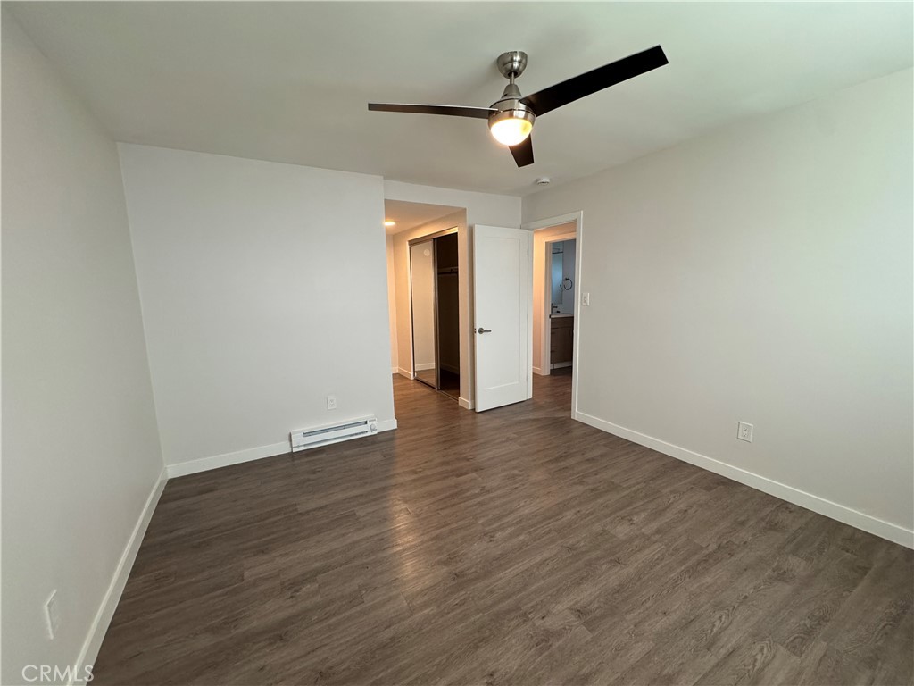 1102 Barbara Street, Unit B Redondo Beach, CA 90277 - Photo 12 of 22 an empty room with wooden floor and chandelier fan