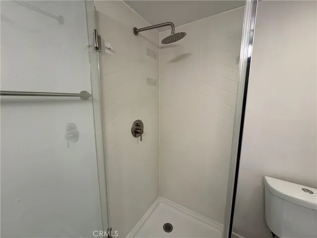 a bathroom with a shower and toilet