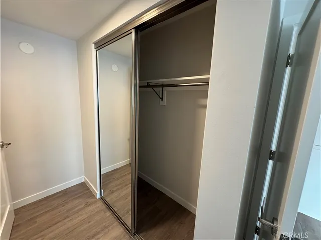 a view of closet area with wooden floor