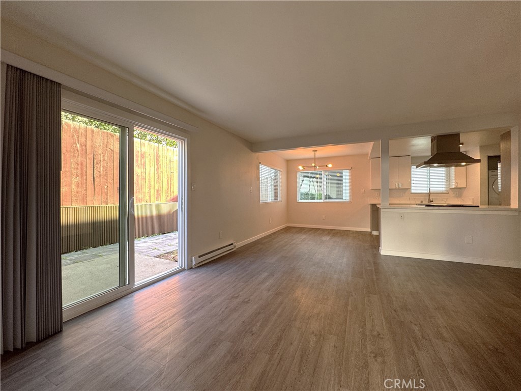 1102 Barbara Street, Unit B Redondo Beach, CA 90277 - Photo 2 of 22 an empty room with wooden floor and windows