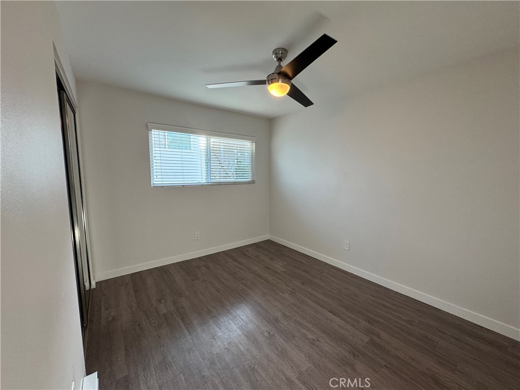 1102 Barbara Street, Unit B Redondo Beach, CA 90277 - Photo 9 of 22 an empty room with wooden floor and windows