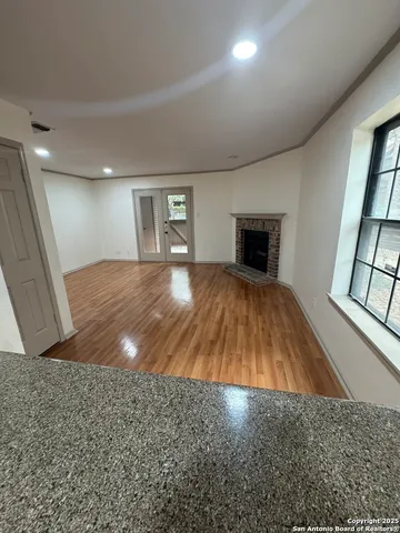 wooden floor in an empty room with a fireplace