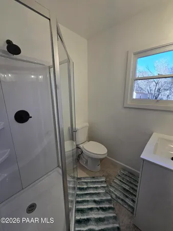 a bathroom with a toilet and a shower