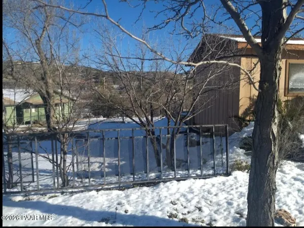 a view of a yard covered with snow