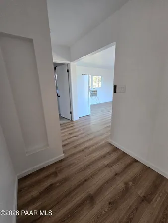 a view of a hallway with wooden floor