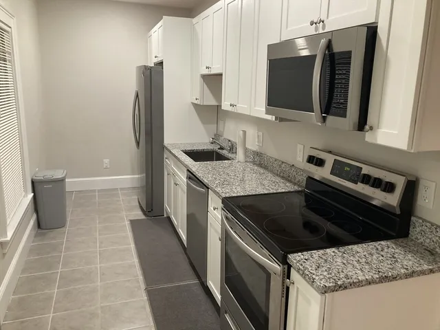 a kitchen with a sink stove and microwave